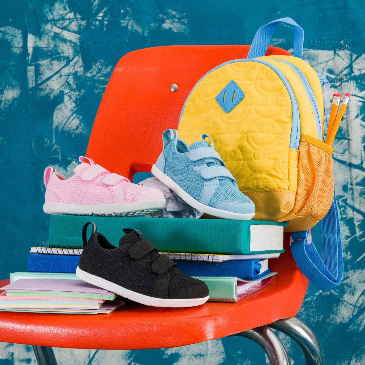 Assortment of school supplies and Dillon Little Kids shoes in several colors