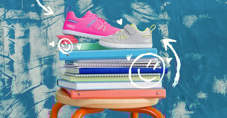 Big Kids Prio Pink and Little Kids Prio Lunar on stack of notebooks for school