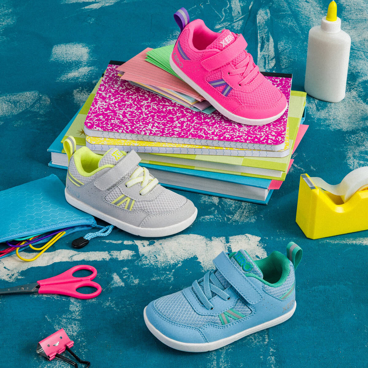 Colorful Prio Little Kids shoes laid out with school supplies